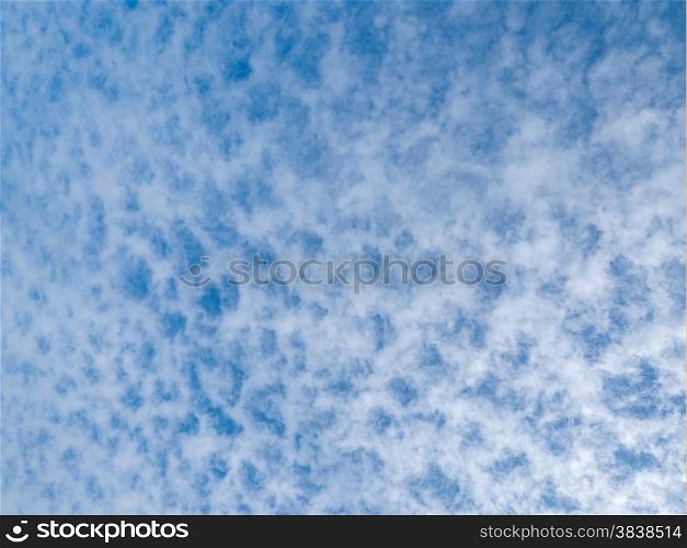 Lots of cloud dots on a partly cloudy blue sky