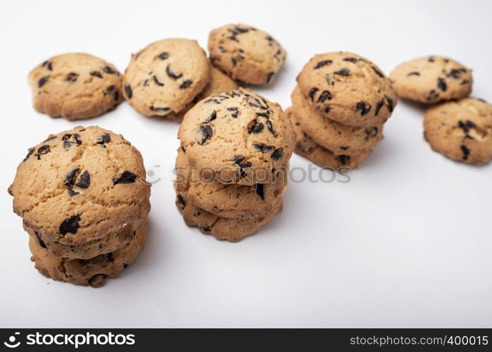 lots of cookies with pieces of chocolate on white background