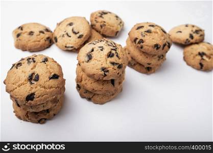 lots of cookies with pieces of chocolate on white background