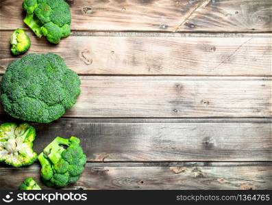 Lots of fresh broccoli. On a wooden background.. Lots of fresh broccoli.