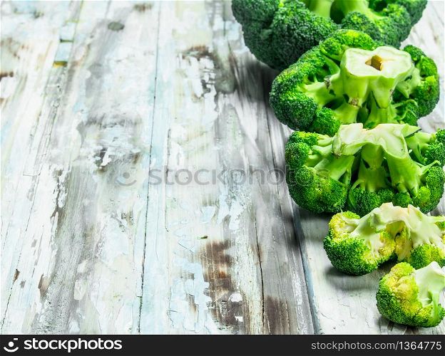 Lots of fresh broccoli. On a wooden background.. Lots of fresh broccoli.