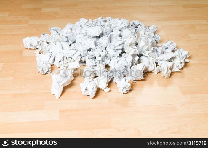 Lots of garbage paper on the wooden floor