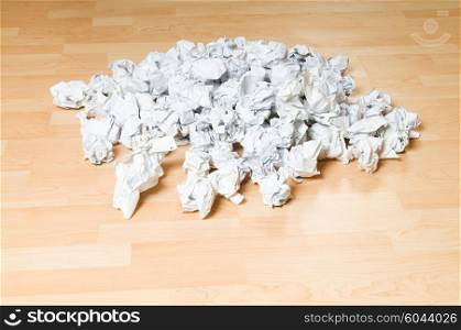 Lots of garbage paper on the wooden floor