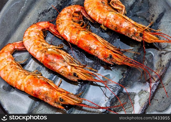 Lots of grilled shrimp on a griddle. Shrimp grilled