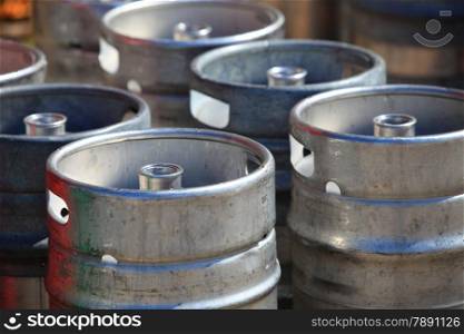 Lots of metal barrels beer kegs at factory brewery