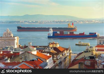 Lots of ships on the Tagus river in Lisbon harbor at sunset. Portugal