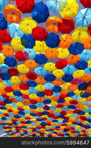 Lots of umbrellas coloring the sky in the city of Agueda, Portugal