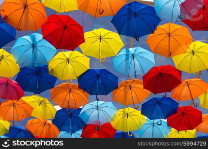 Lots of umbrellas coloring the sky in the city of Agueda, Portugal