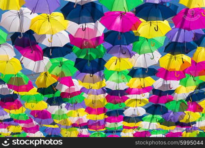 Lots of umbrellas coloring the sky in the city of Agueda, Portugal