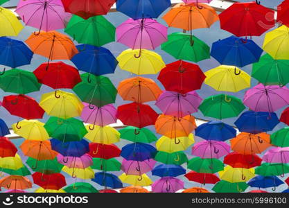 Lots of umbrellas coloring the sky in the city of Agueda, Portugal