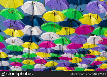 Lots of umbrellas coloring the sky in the city of Agueda, Portugal