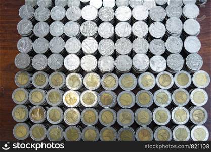 Lots stack coins on wooden desk background texture, Money for business planning investment and saving concept