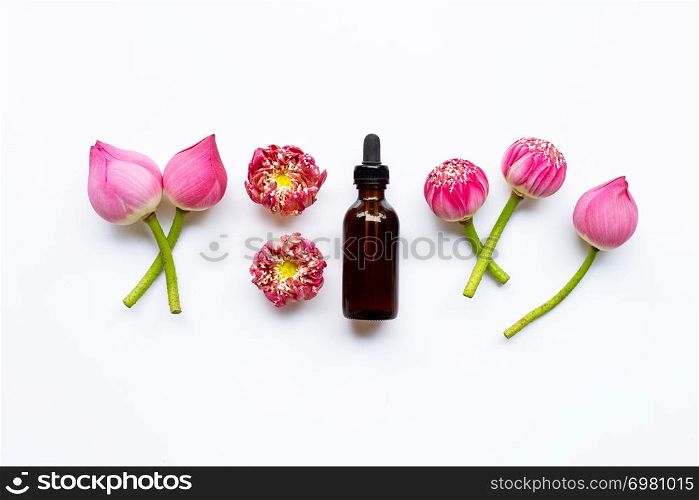 Lotus essential oil with lotus flowers on white background.