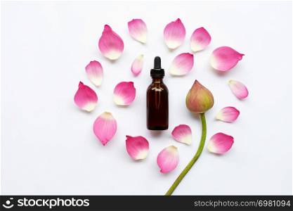 Lotus essential oil with lotus flowers on white background.