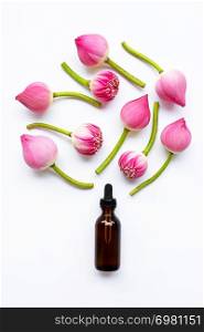 Lotus essential oil with lotus flowers on white background. Top view