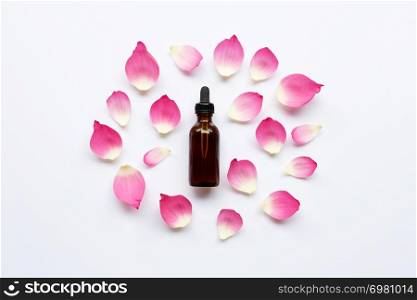 Lotus essential oil with lotus petals on white background.