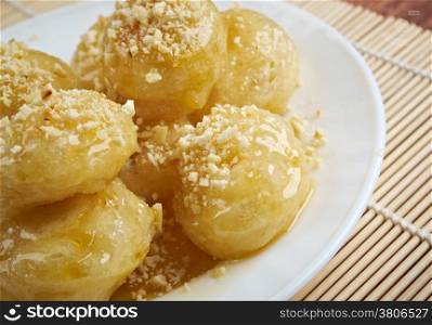 Loukoumades Greek pastry made of deep fried dough soaked in sugar syrup or honey and cinnamon.found in the Mediterranean, Middle East, and South Asia, from the Italian
