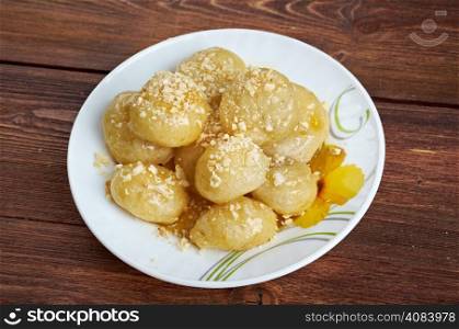 Loukoumades Greek pastry made of deep fried dough soaked in sugar syrup or honey and cinnamon.found in the Mediterranean, Middle East, and South Asia, from the Italian