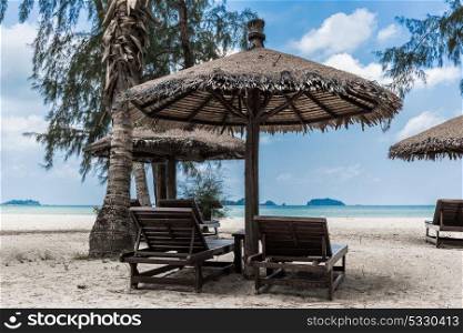 Lounge chairs and a sunshade umbrella on the tropical beach. Lounge chairs and sunshade umbrella on the beach