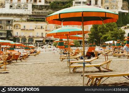 Lounge chairs with beach umbrellas on the beach, Spiaggia Grande, Positano, Amalfi Coast, Salerno, Campania, Italy