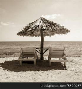Lounge chairs with sunshade on the beach, Bay Islands, Honduras