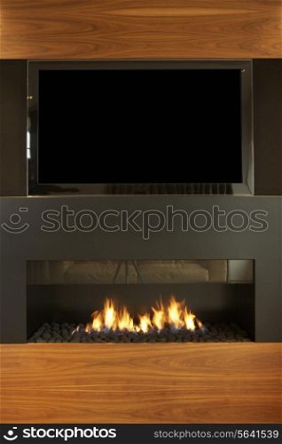 Lounge In Modern Home With TV And Fireplace