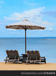 Loungers on the shores of the sunny beach