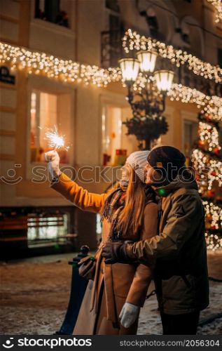 Love among the Christmas lights.. A large portrait of a couple in love against the background of the New Yea