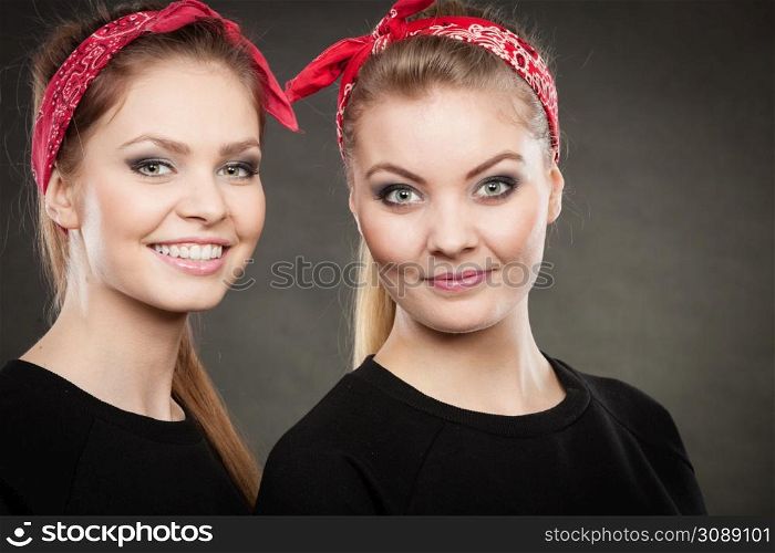 Love and affection in family. Blonde gorgeous sisters stylized on retro pin up vintage style. Two girls in red handkerchief smiling feel enjoyable happy.. Loving sisters in retro pin up stylization.