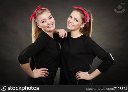 Love and affection in family. Blonde gorgeous sisters stylized on retro pin up vintage style. Two girls in red handkerchief smiling feel enjoyable happy.. Loving sisters in retro pin up stylization.