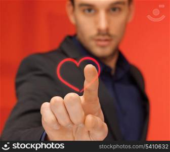 love and business concept - handsome man in suit pressing heart-shaped virtual button