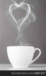 love and coffee. heart silhouette from steaming hot coffee cup