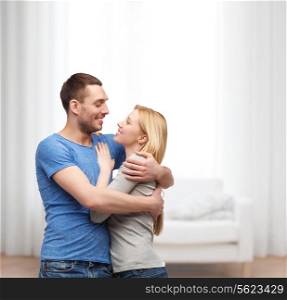 love and family concept - smiling couple hugging and looking at each other