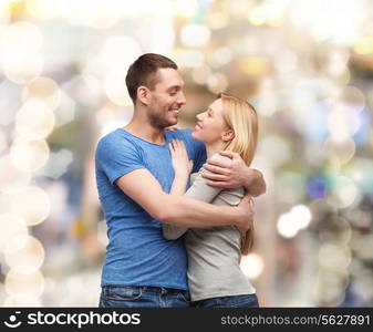 love and family concept - smiling couple hugging and looking at each other