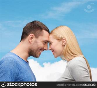 love and family concept - smiling couple looking at each other