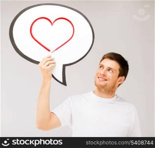 love and happiness concept - smiling young man with text bubble and heart in it