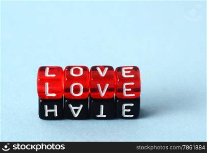 Love and Hate text concept on red and black dices