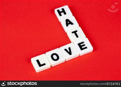 love and hate words on red background