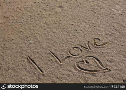 love and heart in the beach sand