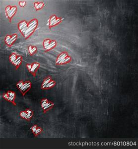 Love and hearts background. Love background. Multicolored hearts on the blackboard