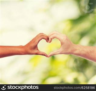love and relationships concept - closeup of woman and man hands showing heart shape. woman and man hands showing heart shape