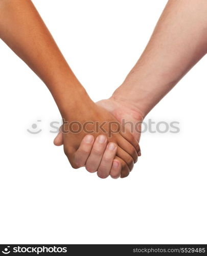 love and relationships concept - closeup of woman and man holding hands