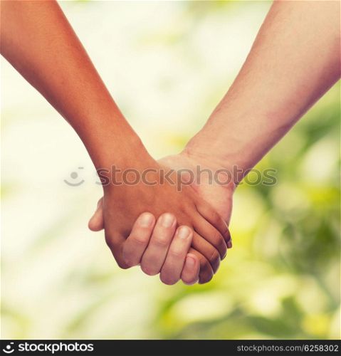 love and relationships concept - closeup of woman and man holding hands. woman and man holding hands