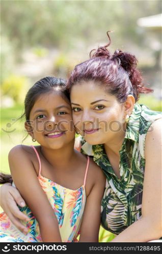 Love between a young mother and her pretty daughter outdoors