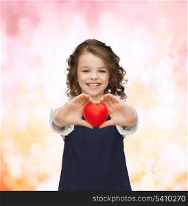 love, children and happiness concept - beautiful girl with small heart