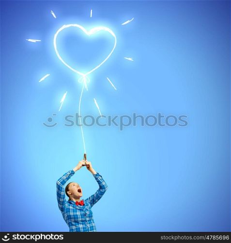 Love concept. Young woman in casual holding heart shaped balloon