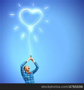 Love concept. Young woman in casual holding heart shaped balloon
