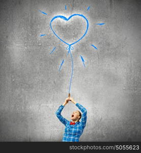 Love concept. Young woman in casual holding heart shaped balloon