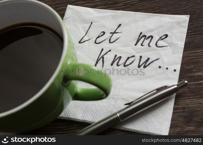 Love confession on napkin. Romantic message written on napkin and cup of coffee on wooden table