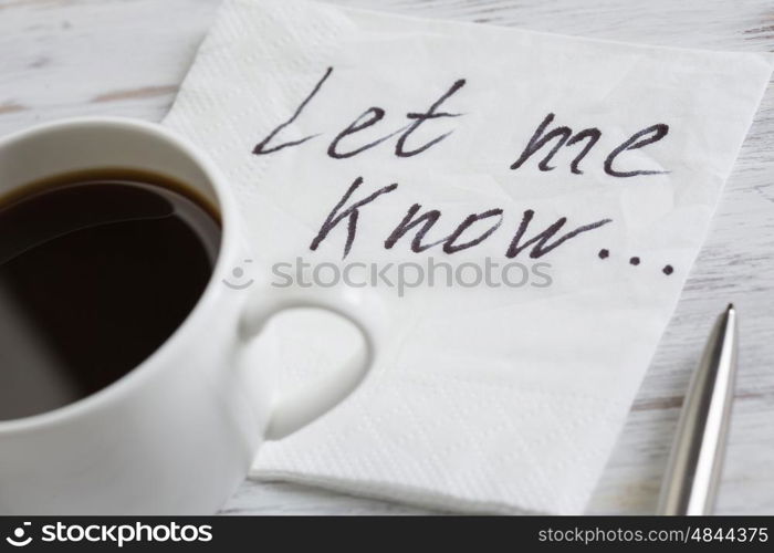 Love confession on napkin. Romantic message written on napkin and cup of coffee on wooden table